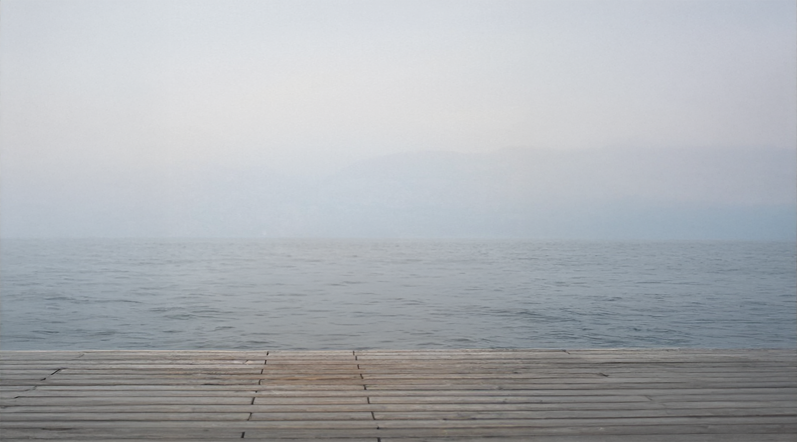 Calm lake water reflecting winter light, symbolizing mental space and relief from pressure of goal-setting  in a busy life.